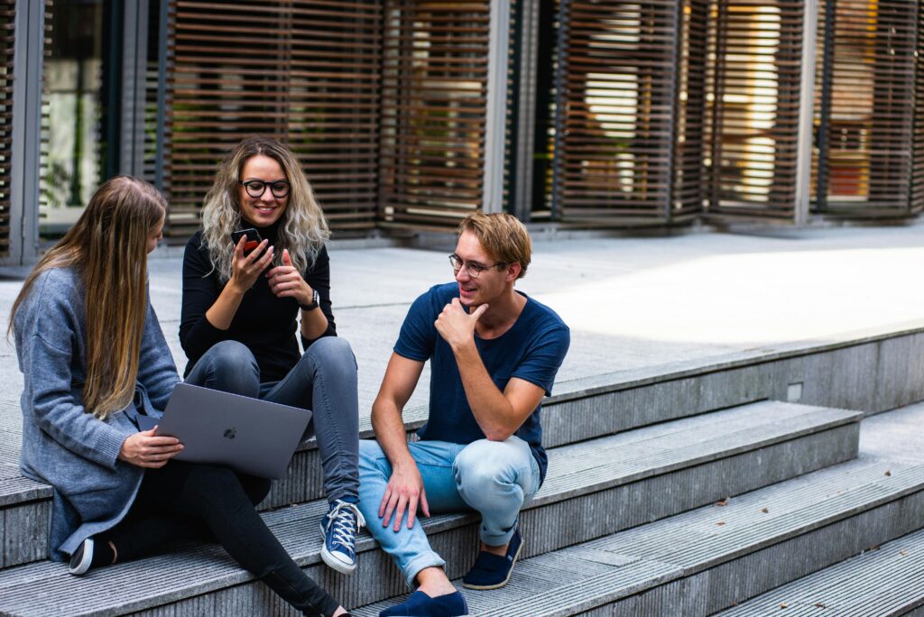 pexels-photo-1438072-1438072 Three Persons Sitting on the Stairs Talking With Each Other